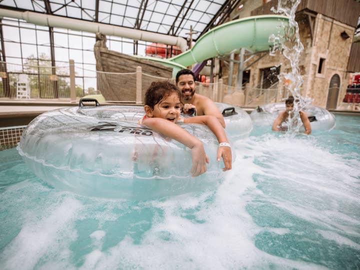 Dad and child floating in lazy river at Pirate's Cay at Fox River Resort in Sheridan, Illinois.