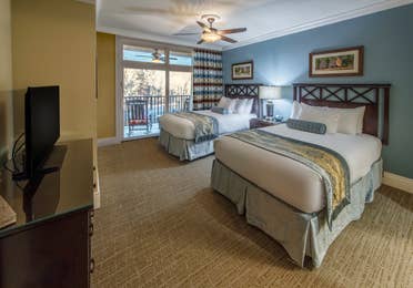 Bedroom with two beds in a villa at Smoky Mountain Resort in Gatlinburg, Tennessee.