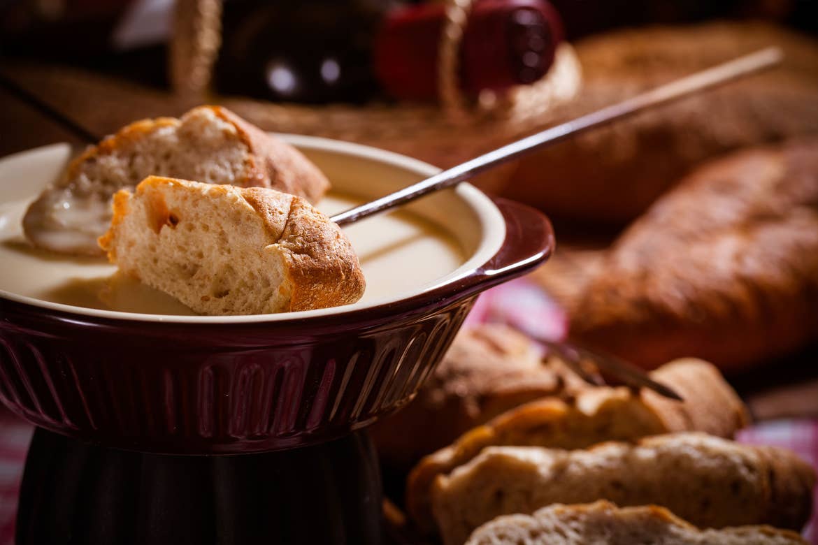 cheese fondue pot with bread on sticks.