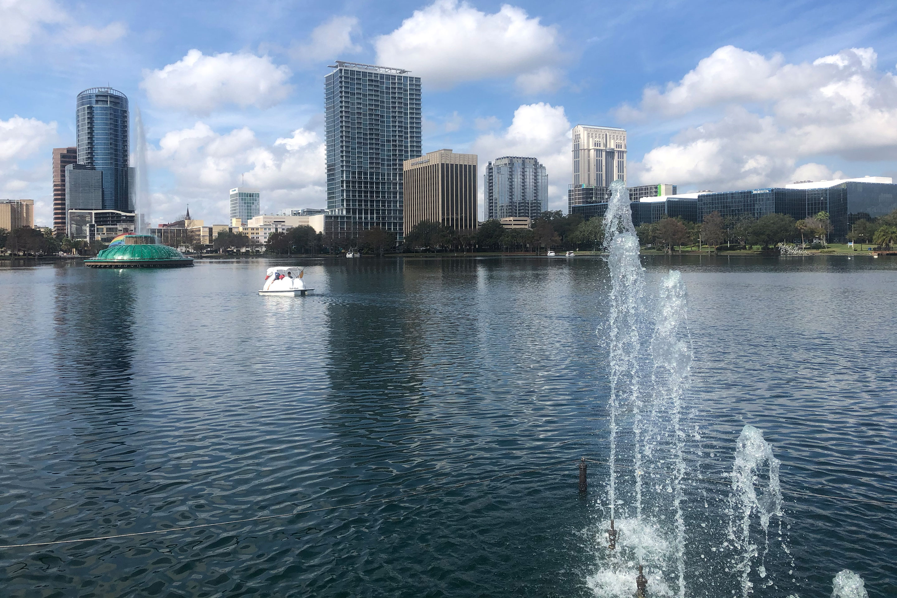 Lake Eola skyline with Swan boat and water feature.