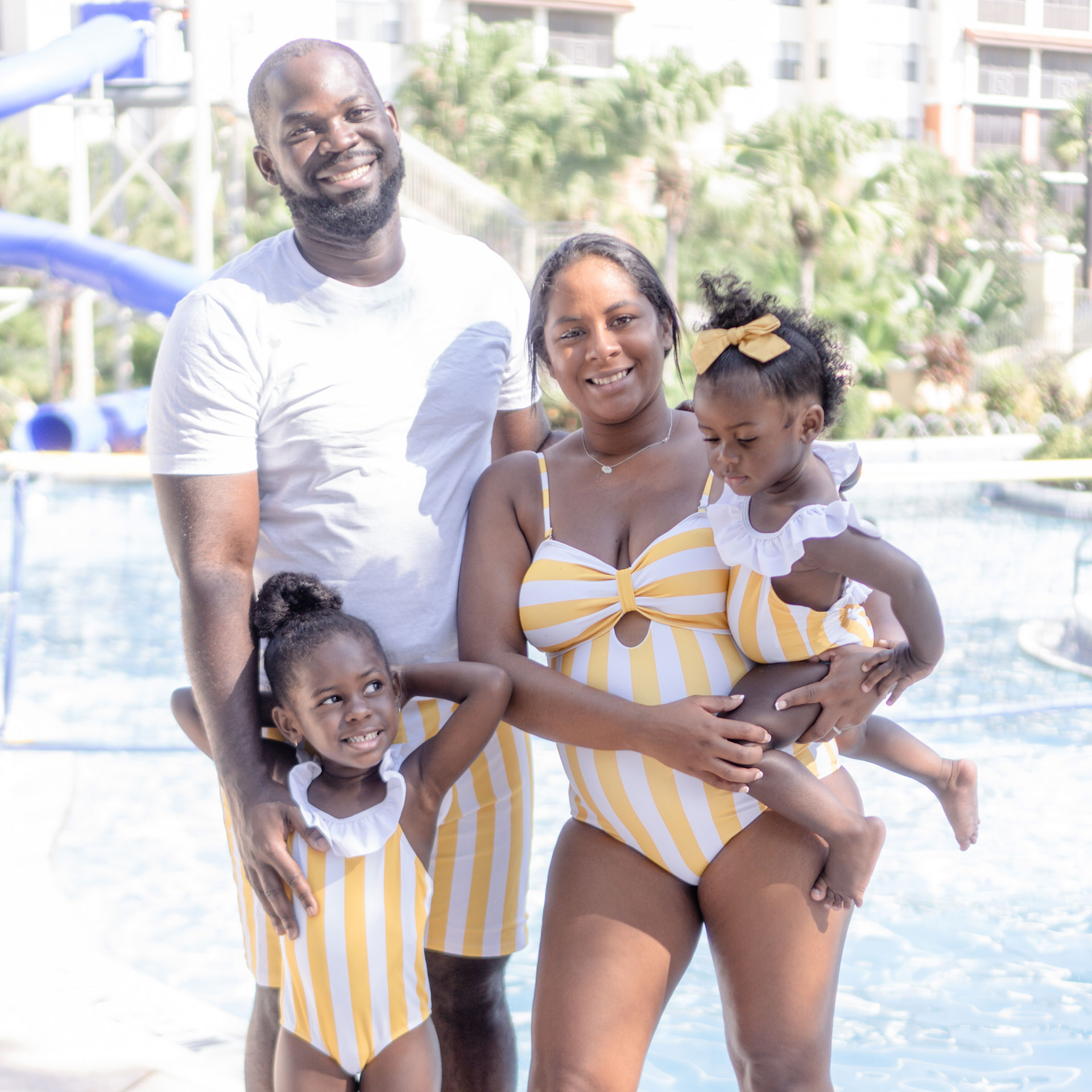 Author, Kimberly Gelin (middle-right), poses with her family in front of our pool at Orange Lake resort located in Florida.