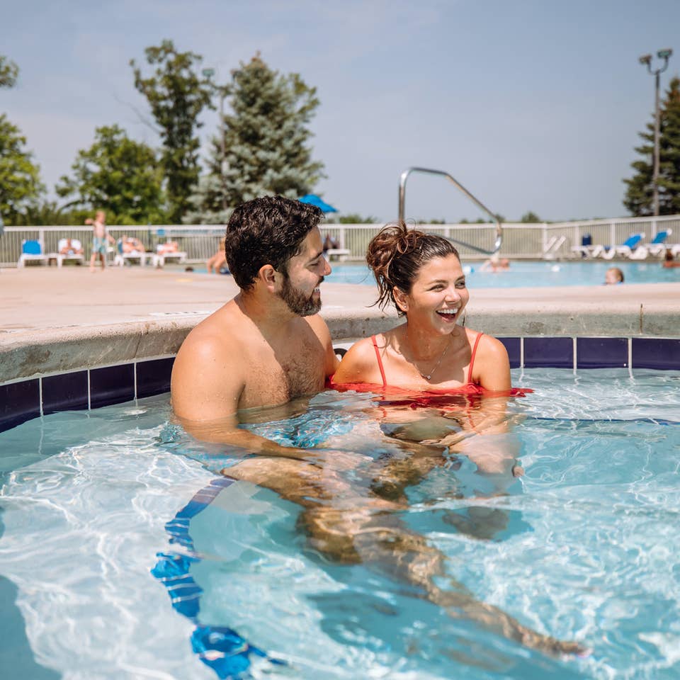 Dad and child in outdoor pool at Fox River Resort in Sheridan, Illinois.