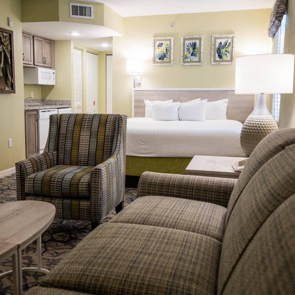 Couch, kitchenette and bed in a villa at Cape Canaveral Resort.