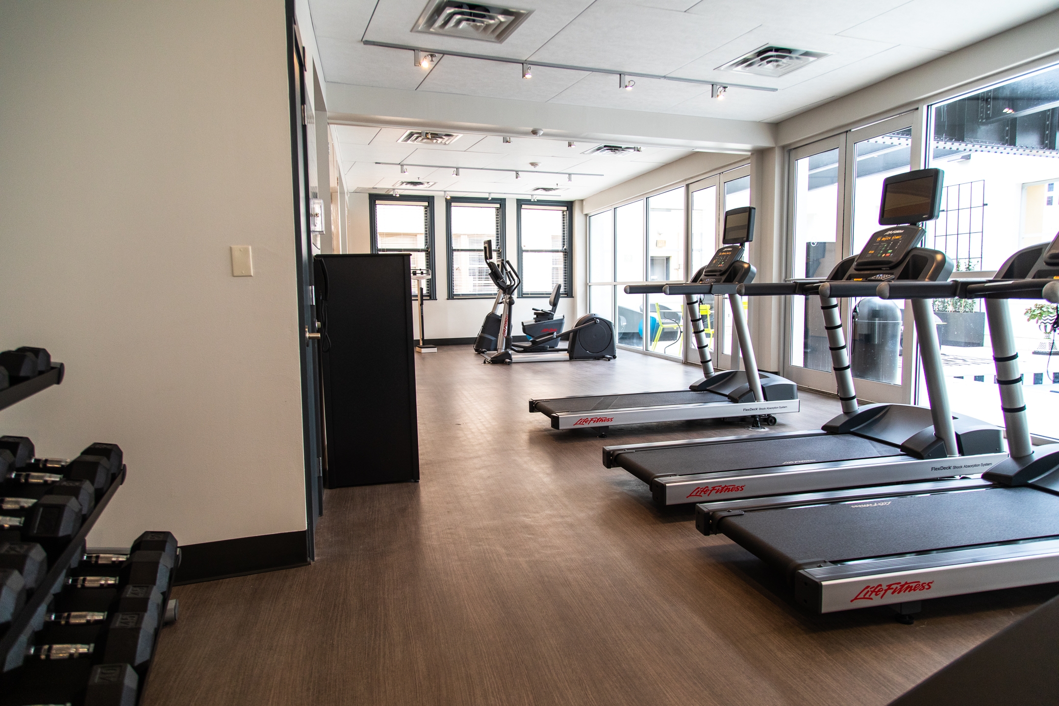 Fitness center with treadmills, free weights and stationary bicycle at New Orleans Resort in Louisiana.