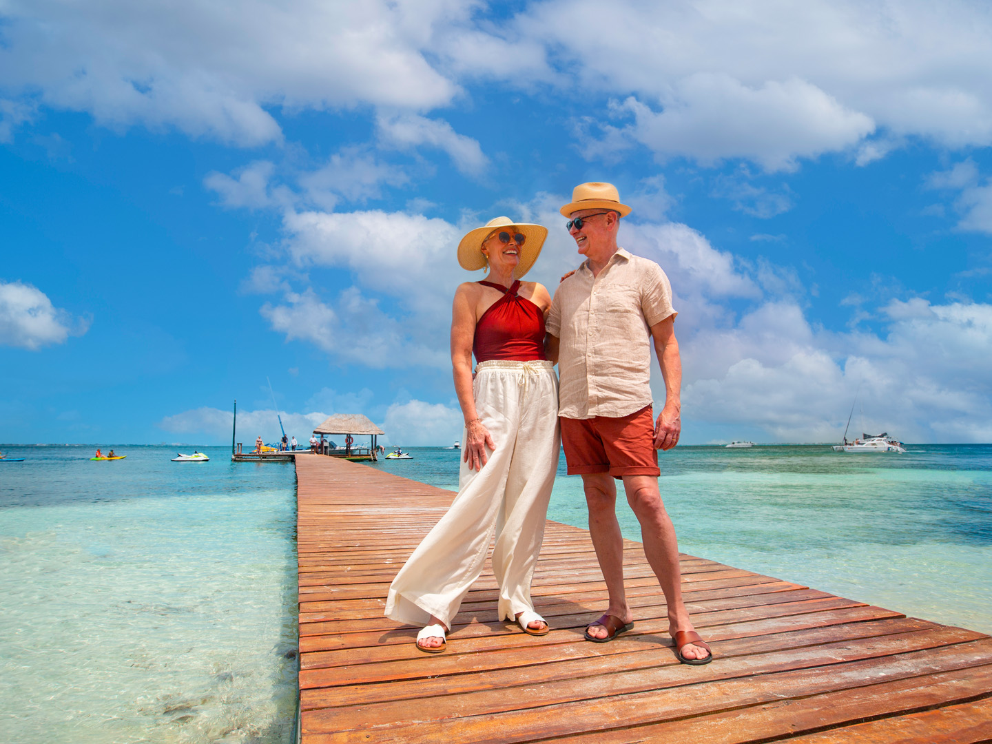 Couple standing on pier at the beach.