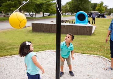 Two children playing tetherball at Holiday Hills Resort in Branson, Missouri.