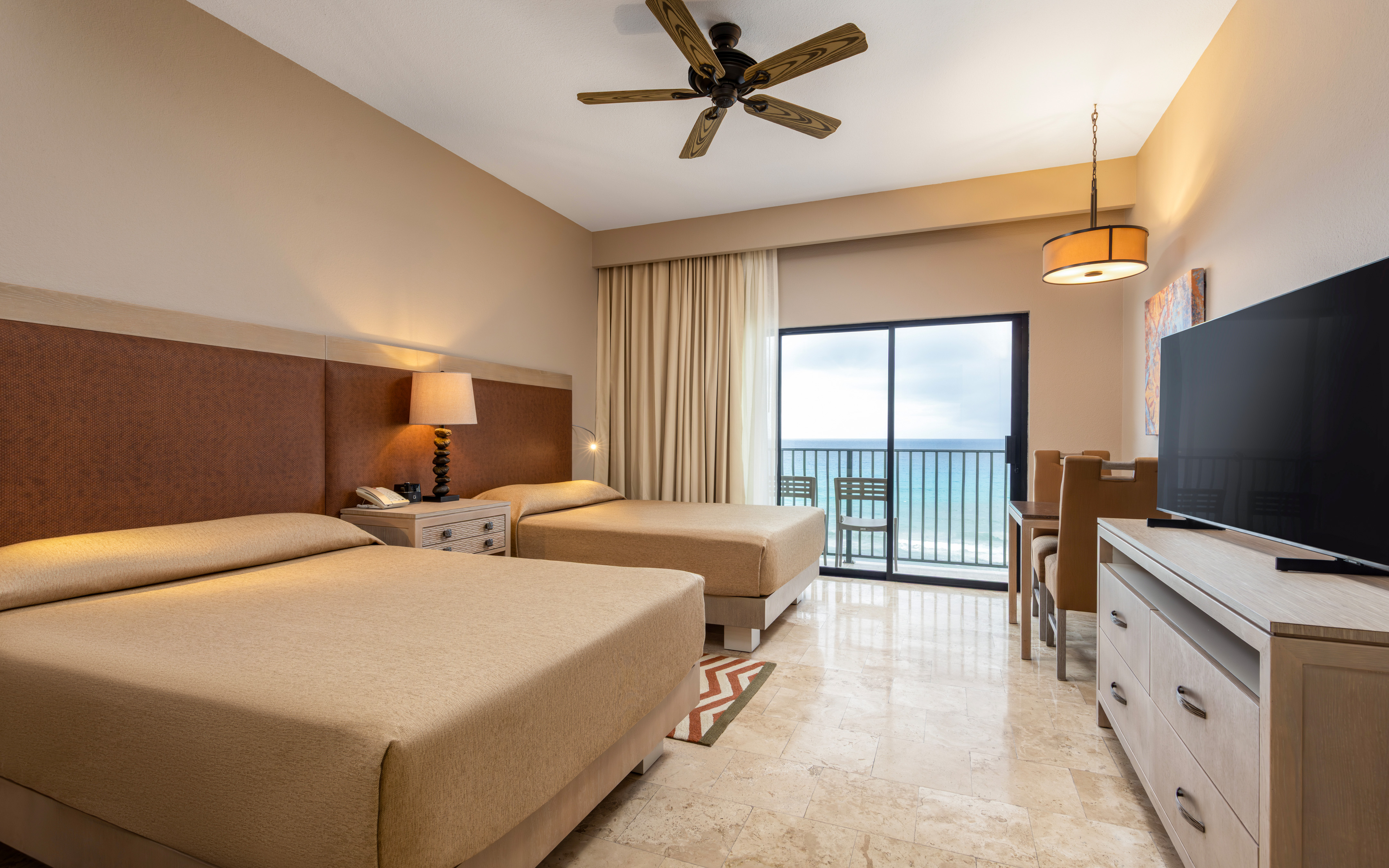 Beachfront room with two beds and a stunning ocean view.