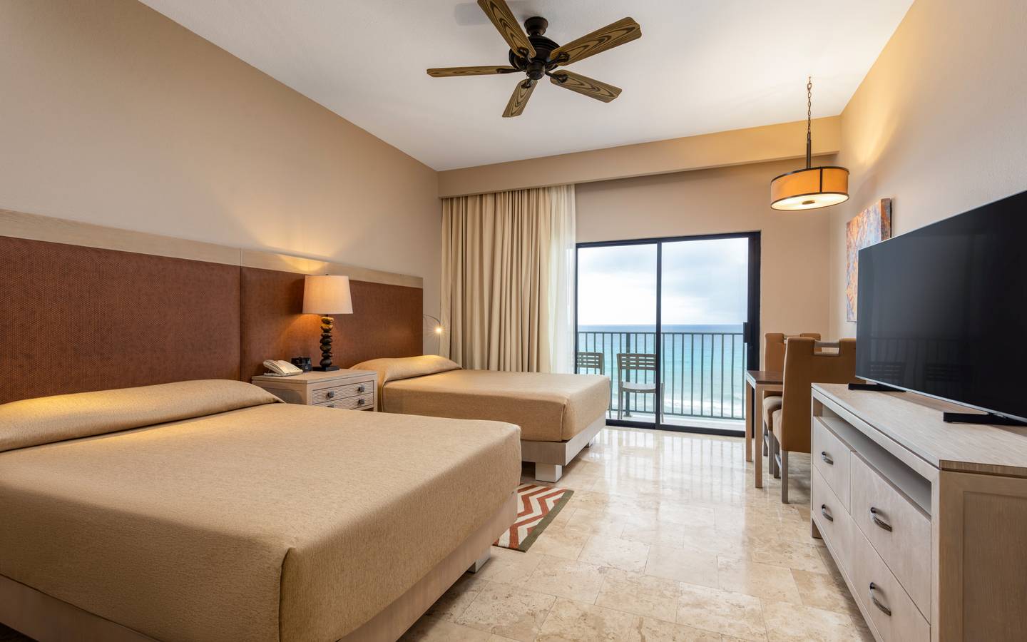 Beachfront room with two beds and a stunning ocean view.