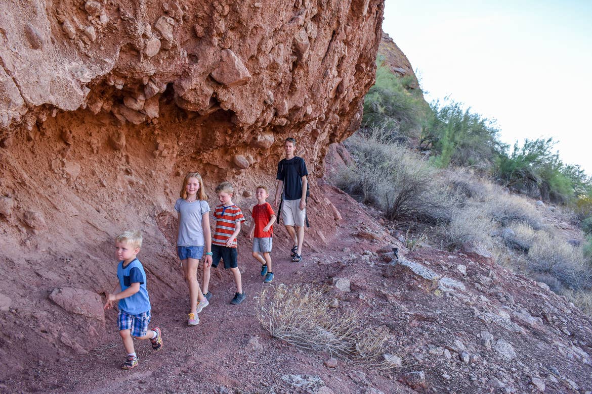 The Averett family hikes one of the trails near a rock formation at Papago Park.