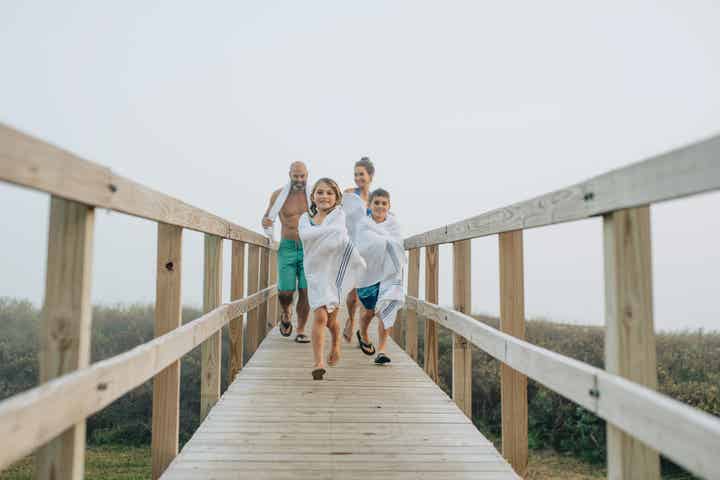 Family walking down a pier