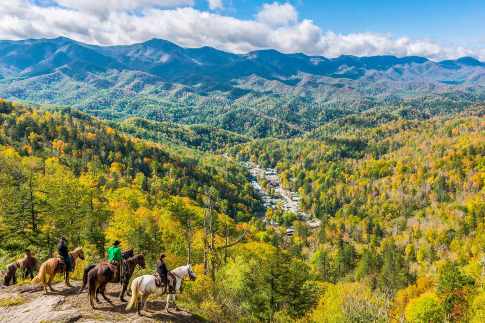Horseback riders overlooking colorful Smoky Mountains valley and distant town below.
