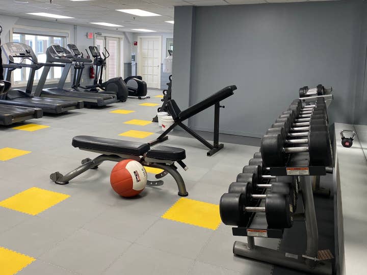 Fitness center with dumbbells, weight benches and treadmills at Mount Ascutney Resort in Brownsville, Vermont.