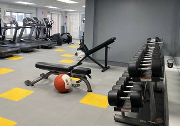 Fitness center with dumbbells, weight benches and treadmills at Mount Ascutney Resort in Brownsville, Vermont.