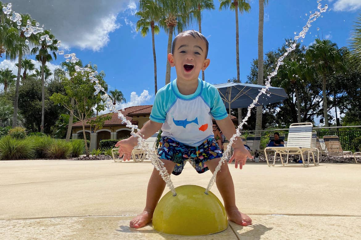 Author, Danny Pitaluga's son, Joey, wears his swimsuit near a fountain park area at our Orange Lake Resort located in Orlando, Florida.