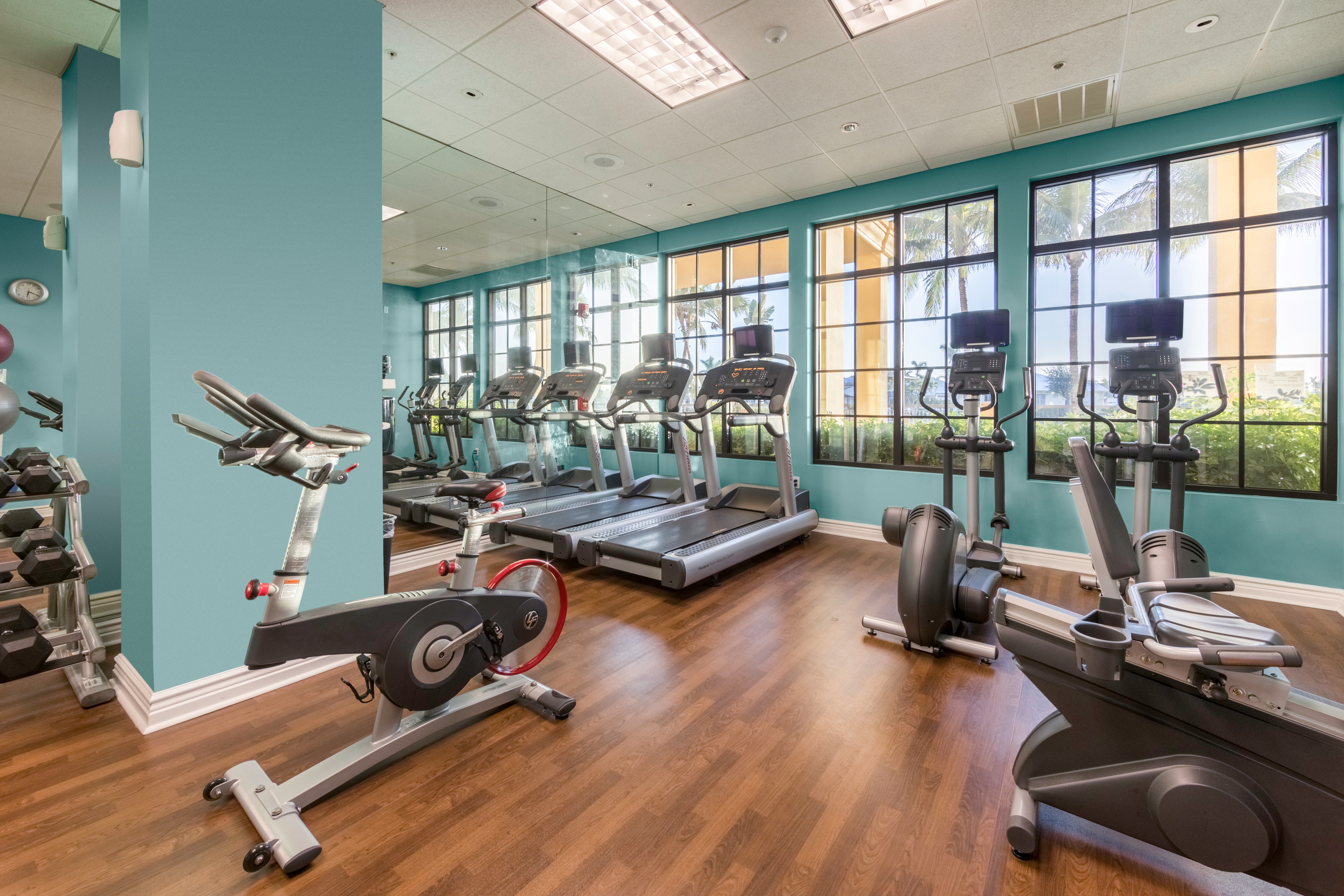 Fitness center with treadmills and elliptical machines at Sunset Cove Resort in Marco Island, Florida.