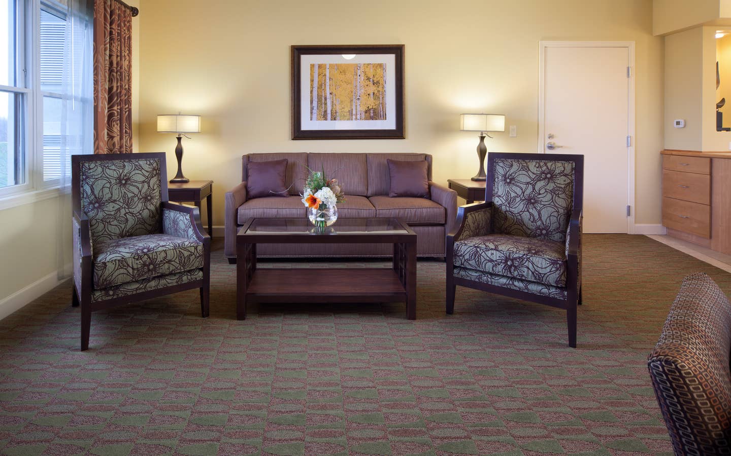Living room with couch and two accent chairs in a villa at Lake Geneva Resort