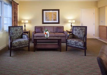Living room with couch and two accent chairs in a villa at Lake Geneva Resort