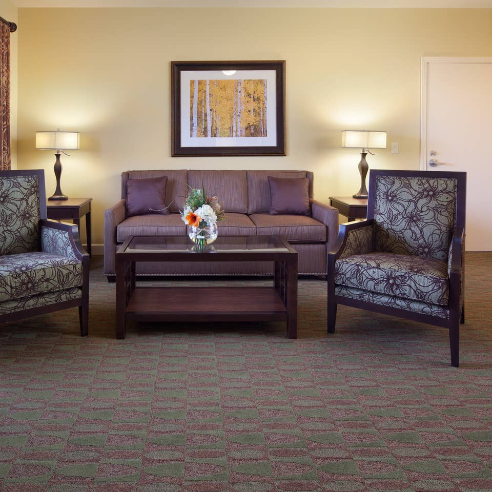 Living room with couch and two accent chairs in a villa at Lake Geneva Resort