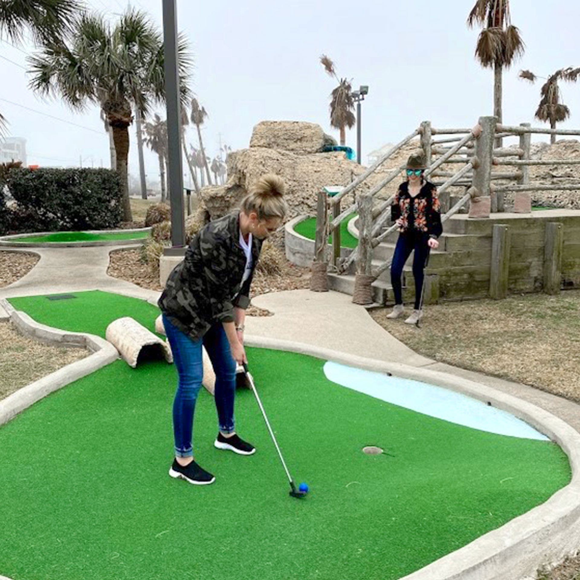 Featured Contributor, Amanda Nall (left) plays mini-golf with her friend at our Galveston Beach Resort in Galveston, Tx.
