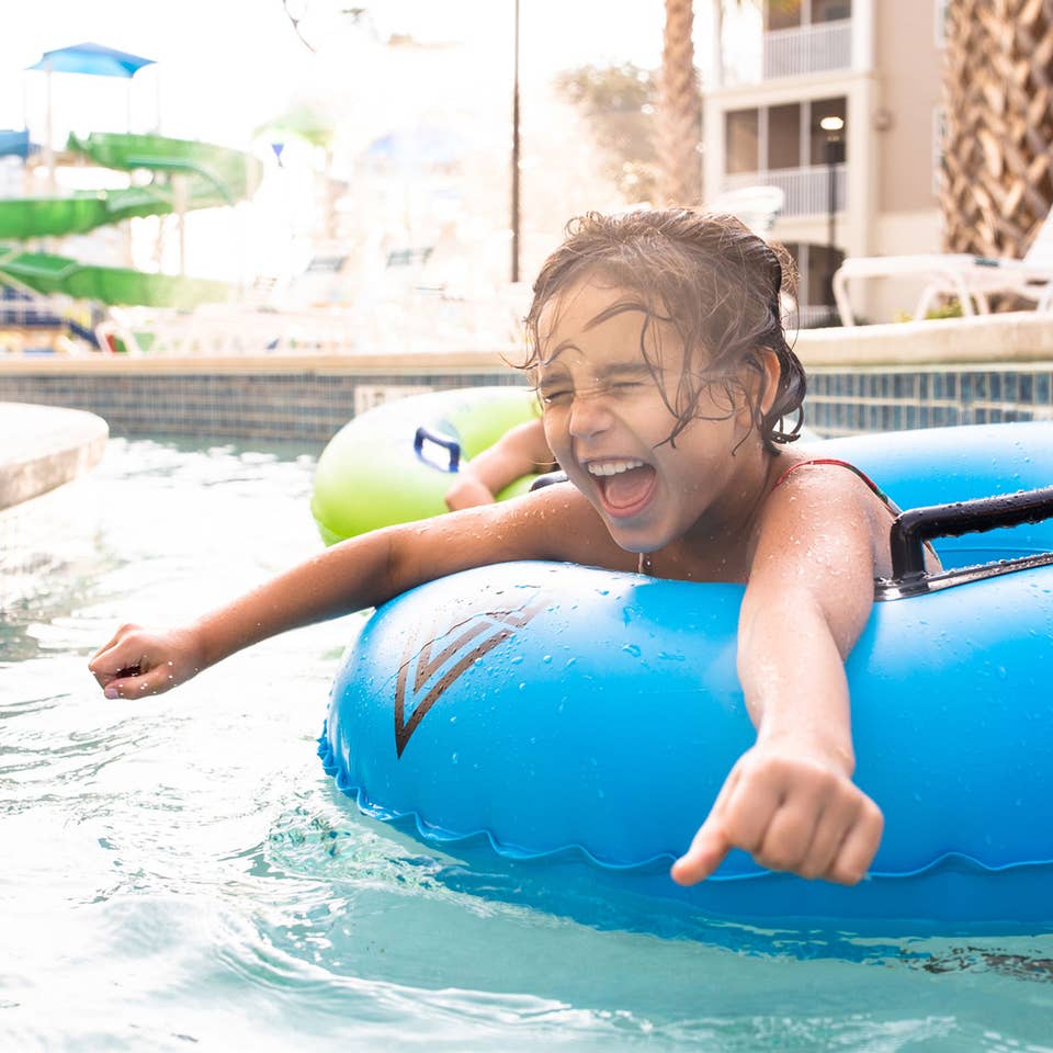 Author, Brenda Rivera Stearns' daughter, Victoria, floating along the lazy river in a blue innertube at our South Beach resort in Myrtle BEach, South Carolina.