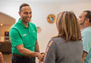 A salesman shaking the hand of a woman