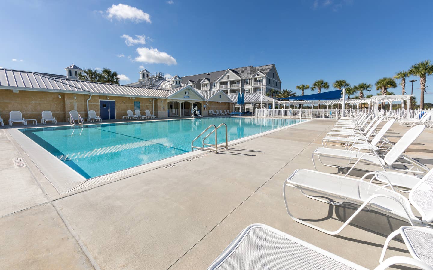 Outdoor pool with lounge chairs at Orlando Breeze Resort near Orlando, Florida.