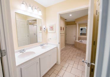 Bathroom with a double sink in a two-bedroom presidential villa at Fox River Resort in Sheridan, Illinois.