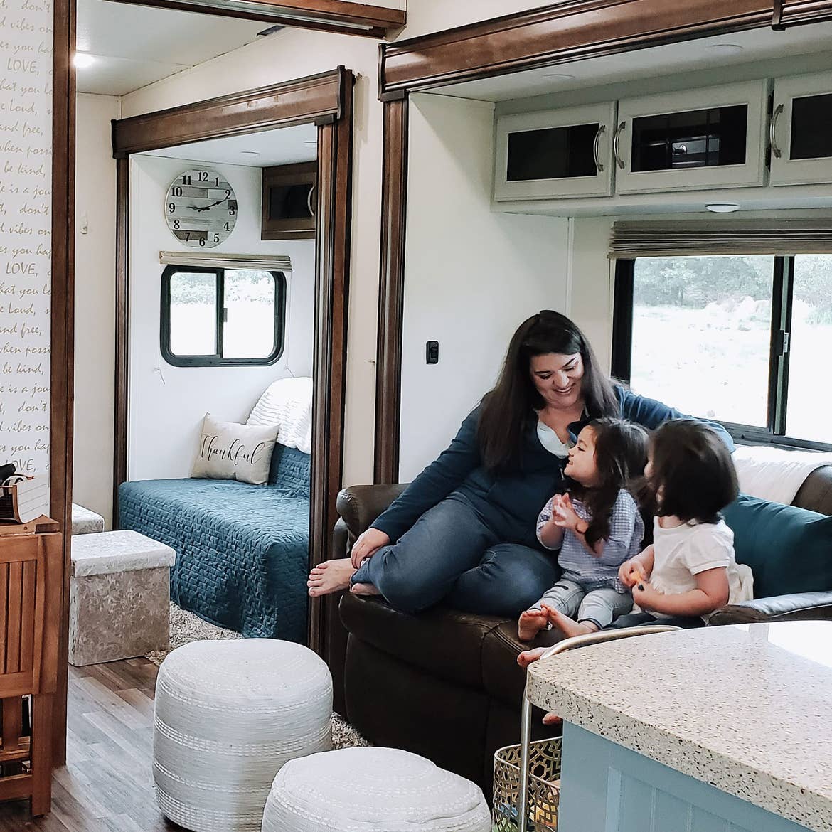 Angelica (left) sits with her two daughters in their RV.