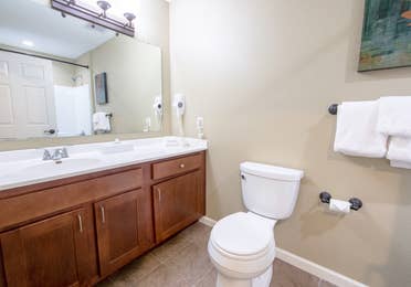 Bathroom with sink and toilet in a studio villa at Fox River Resort in Sheridan, Illinois.