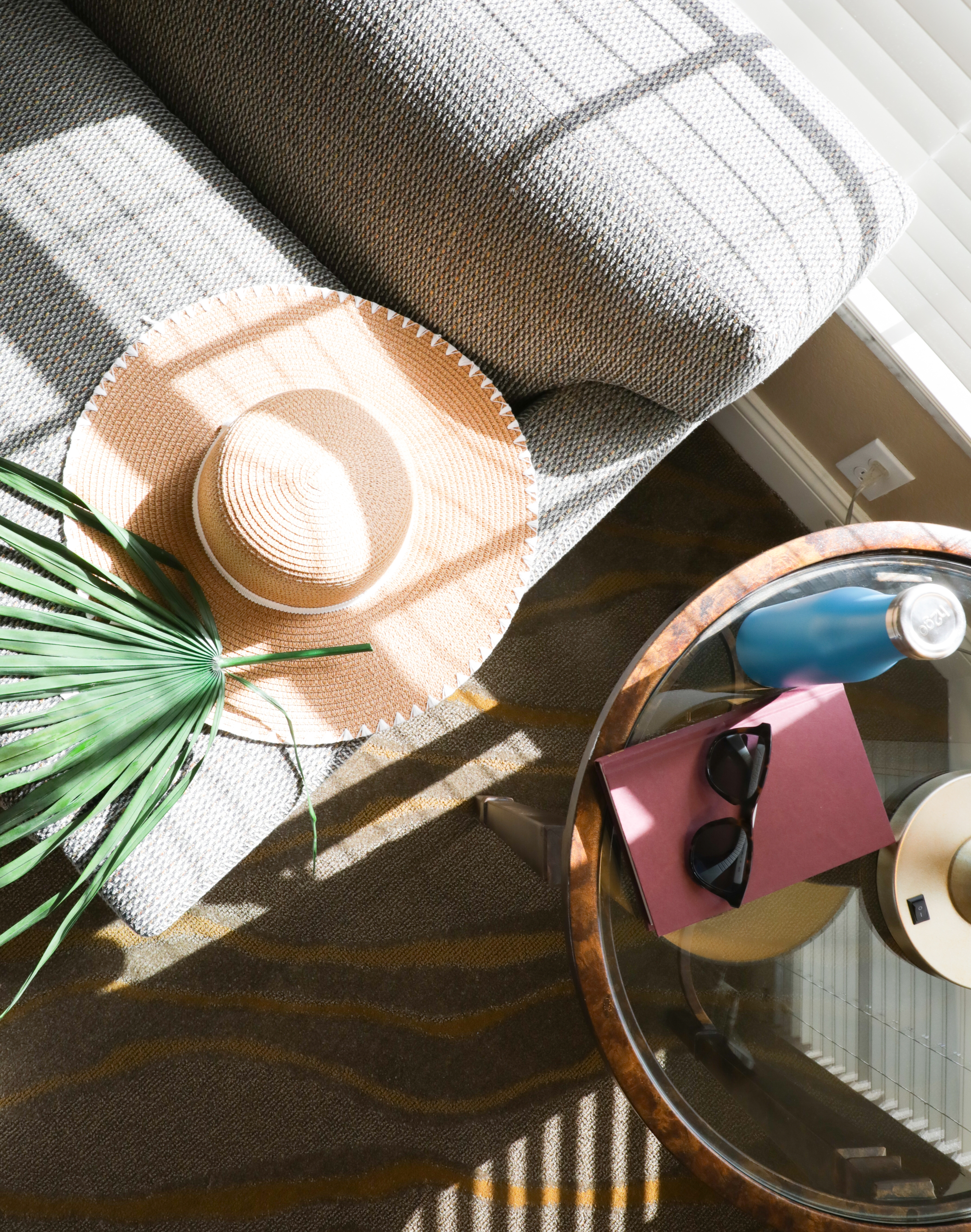 Closeup of table with sunglasses and sun hat in West Village at Orange Lake Resort near Orlando, FL