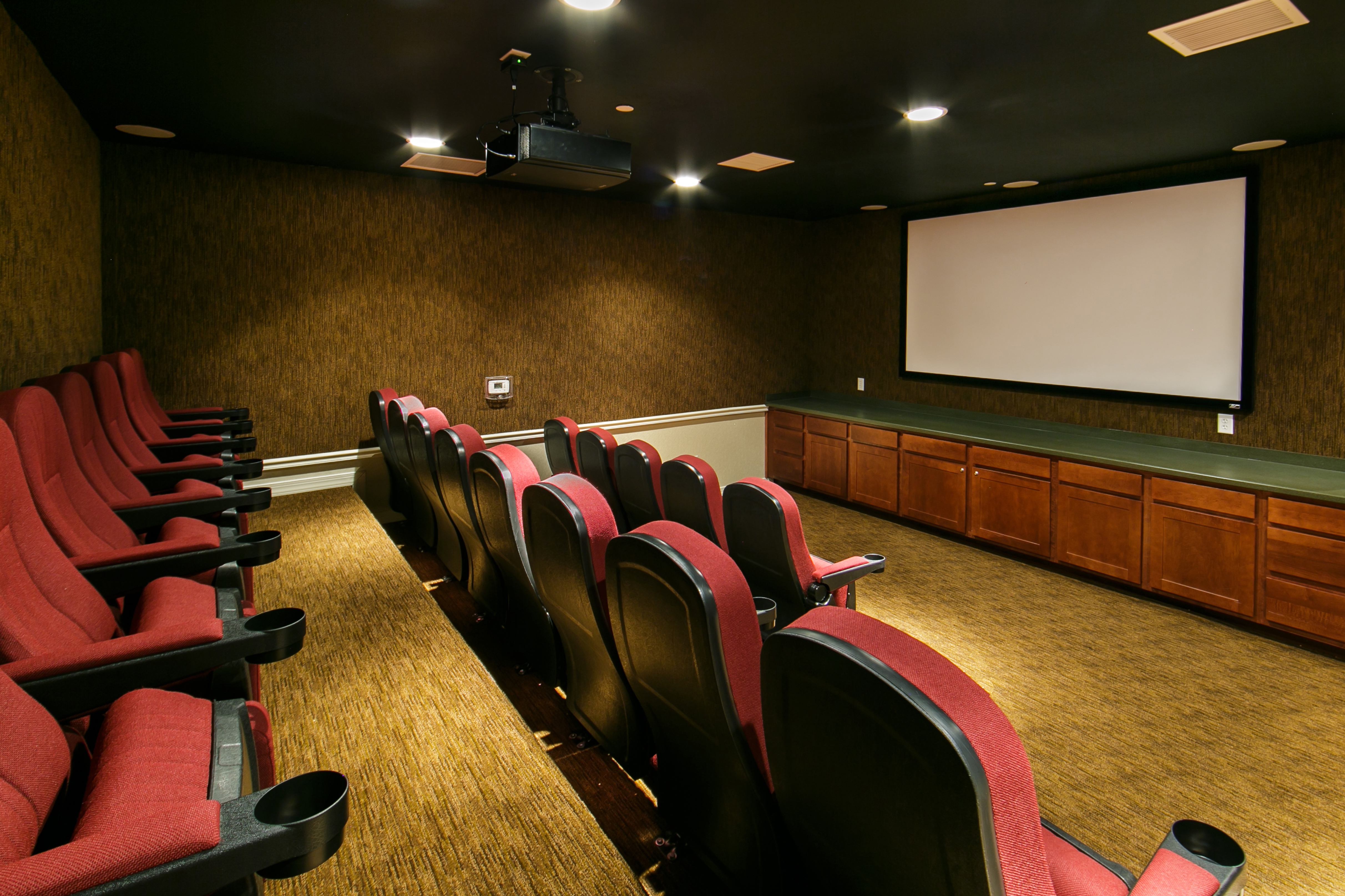 Movie theater with red seats at Orlando Breeze Resort in Florida.