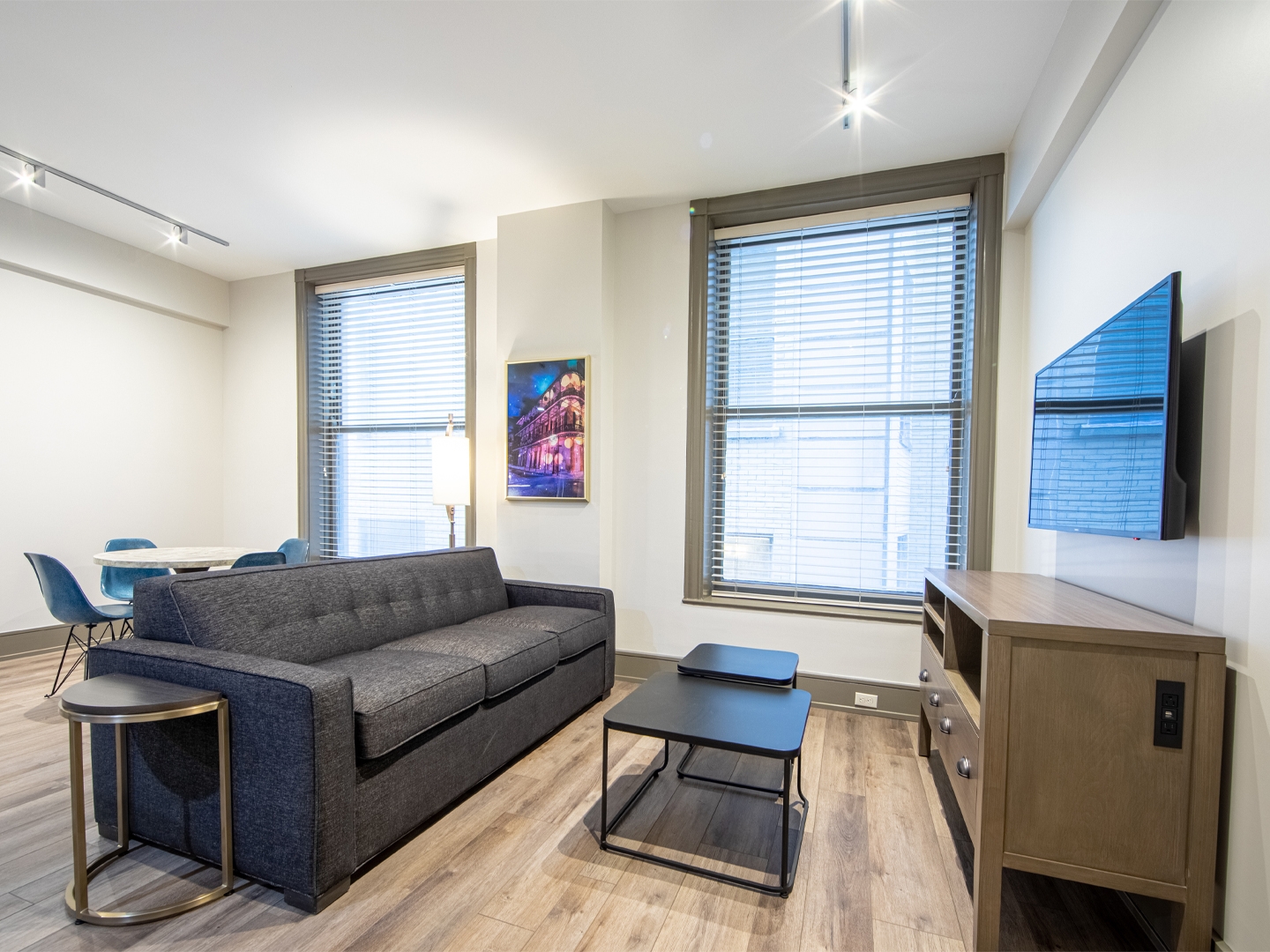 Two bedroom villa living area with couch, two windows and TV at New Orleans Resort in Louisiana.