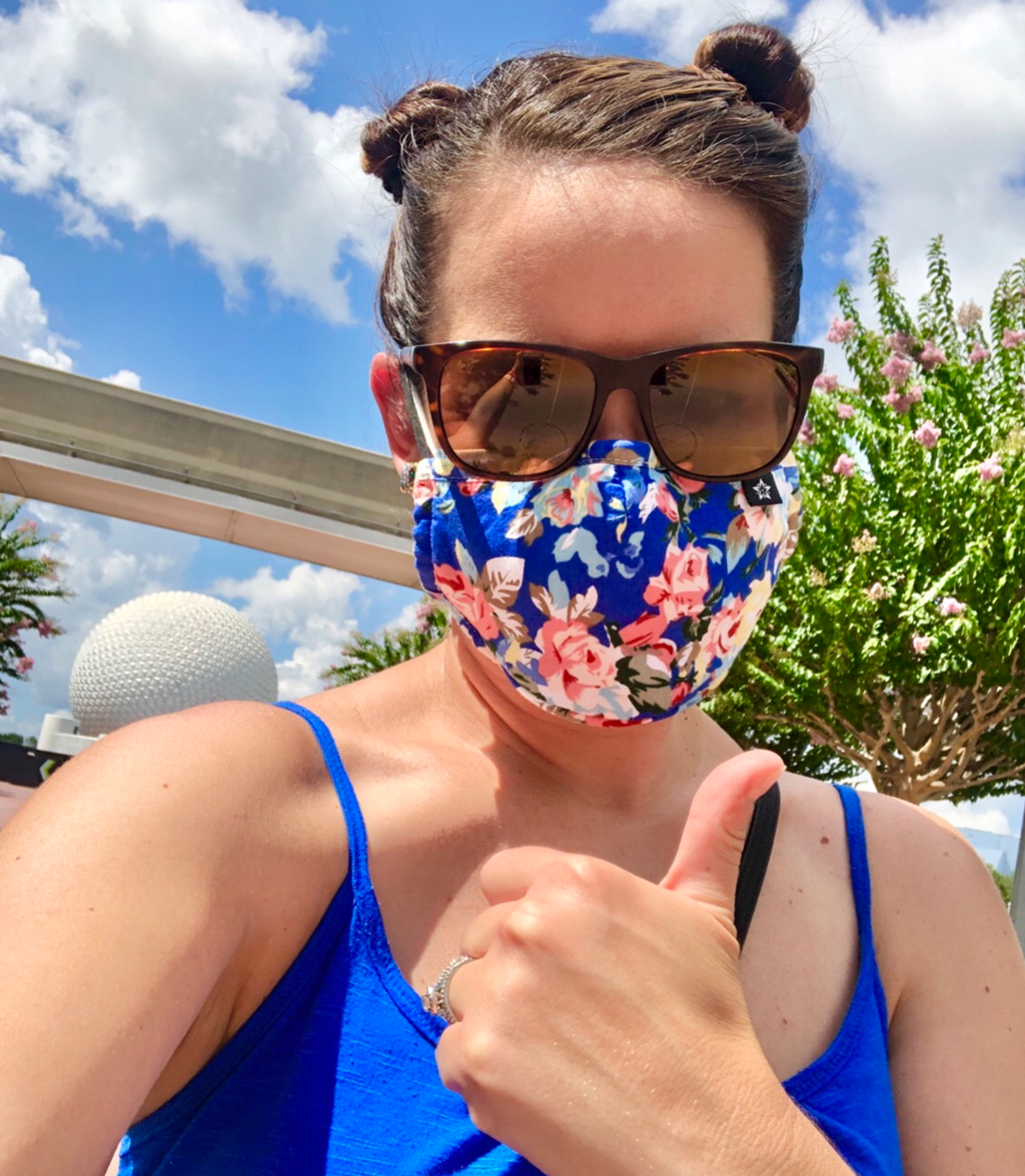 Jenn appears in front of the Monorail and Spaceship Earth at Epcot.