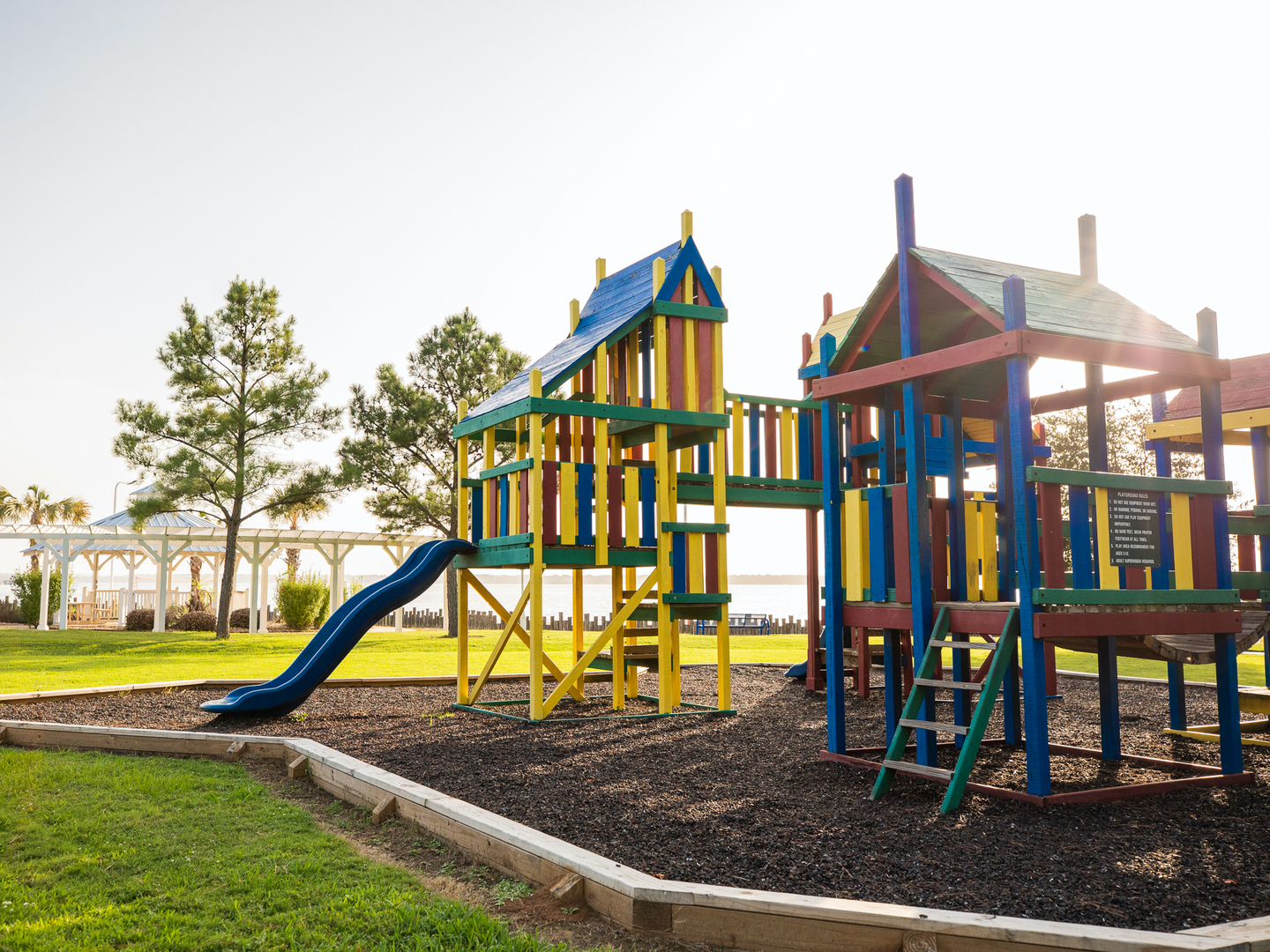 Outdoor playground painted in yellow, green, red and blue at Villages Resort in Flint, Texas.