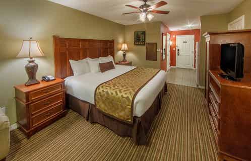 King bed and flat screen TV in a studio room at Piney Shores Resort in Conroe, Texas
