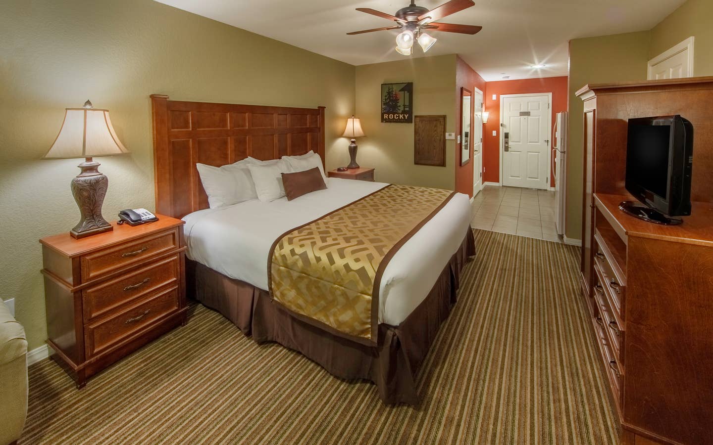 King bed and flat screen TV in a studio room at Piney Shores Resort in Conroe, Texas