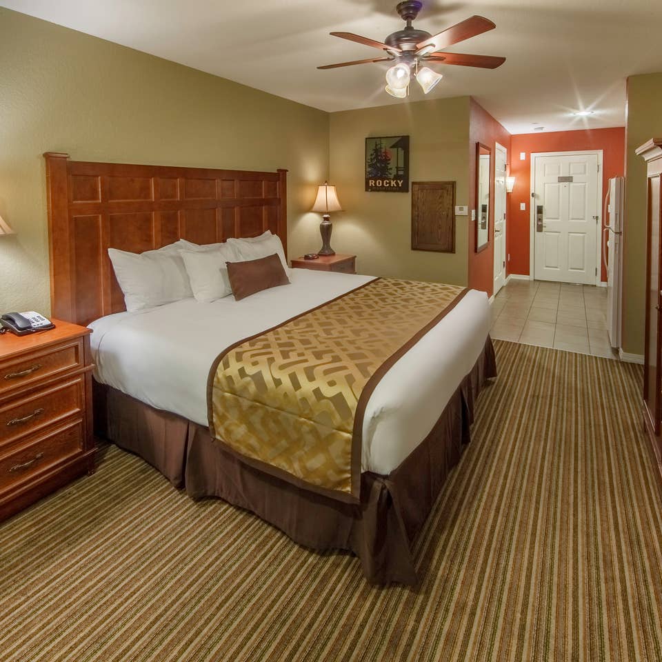 King bed and flat screen TV in a studio room at Piney Shores Resort in Conroe, Texas