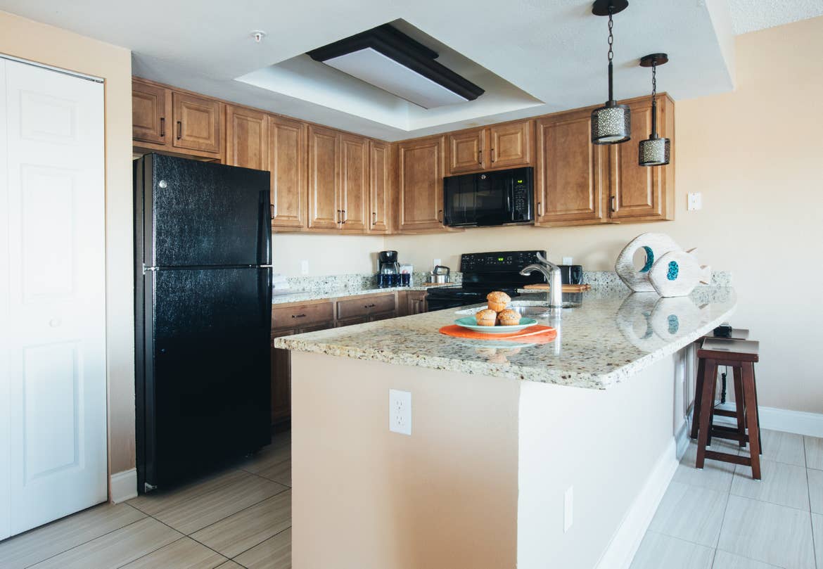 Kitchen with fridge, sink, oven, and microwave in West Village at Orange Lake Resort near Orlando, FL