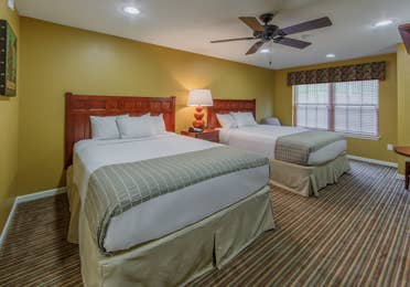 Two queen beds with a window view in a studio villa at Fox River Resort in Sheridan, Illinois