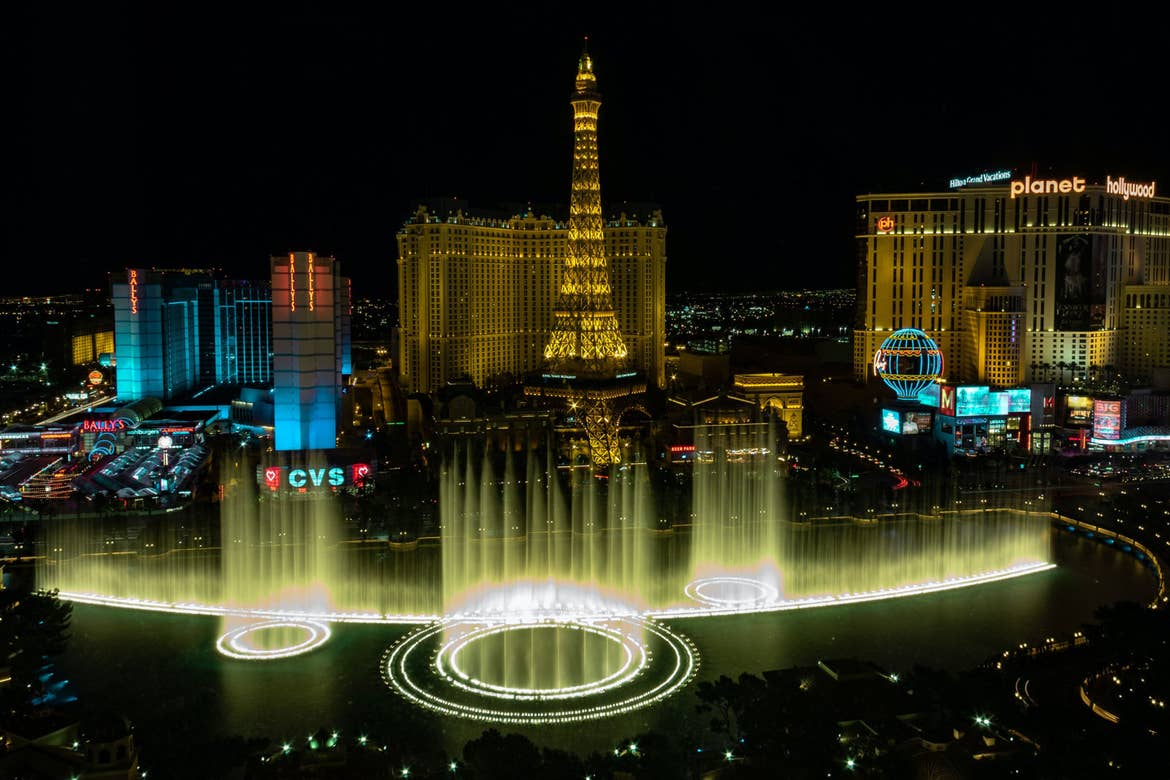 The Las Vegas strip at night with lights and the Bellagio 'Dancing fountains.'