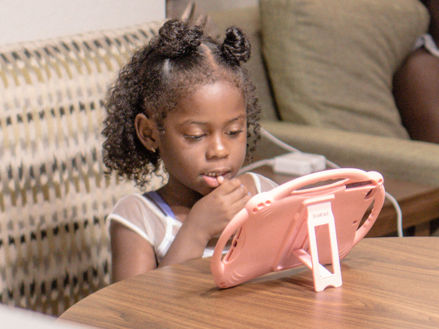 Author, Kimberly Gelin's daughter (left), sits at her dining table in our Villa at Orange Lake Resort in Florida with her iPad for virtual learning.