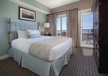 Master bedroom with access to furnished balcony in a two-bedroom villa at Galveston Beach Resort