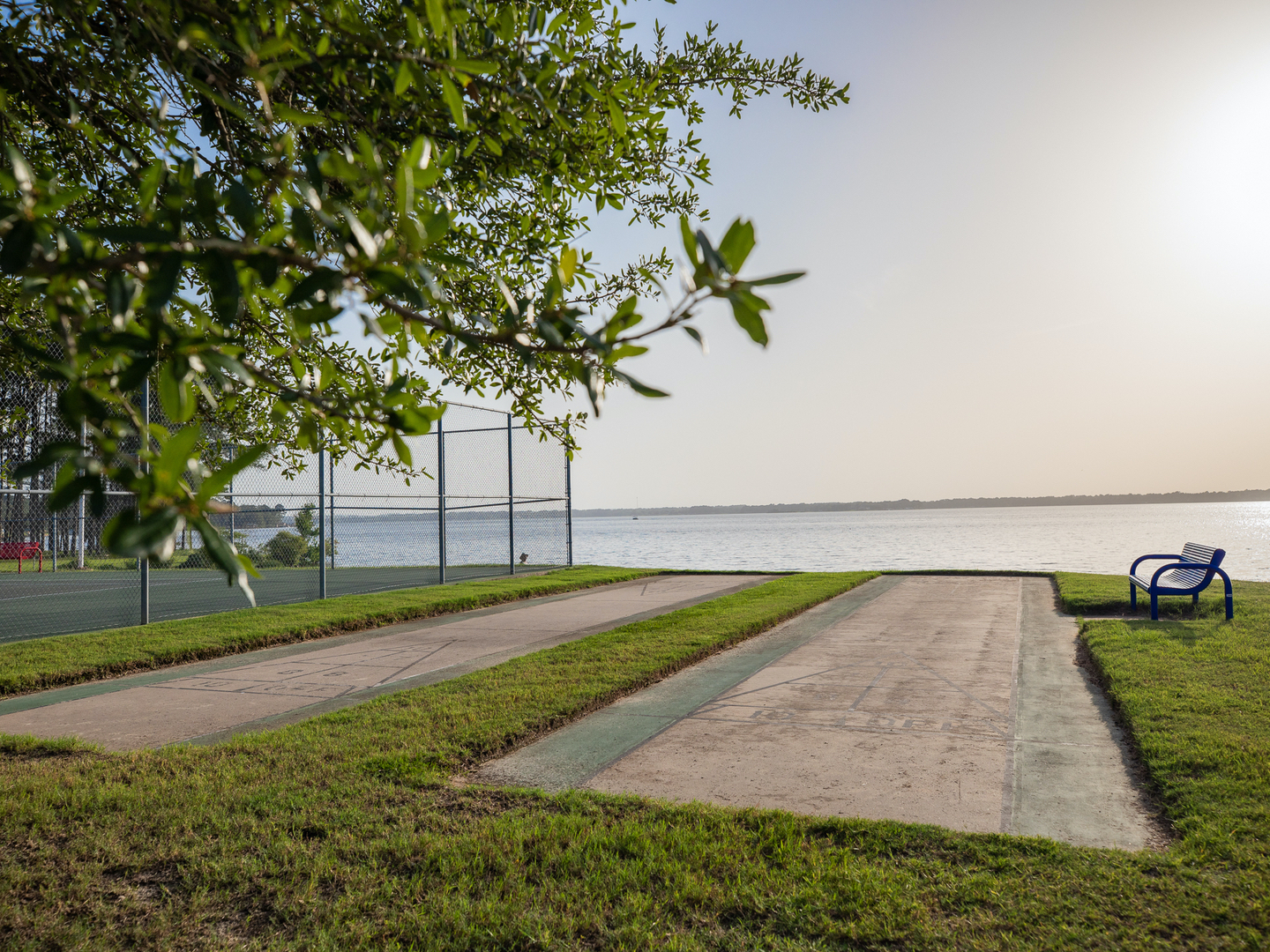 Outdoor shuffleboard court with view of lake at Villages Resort in Flint, Texas.