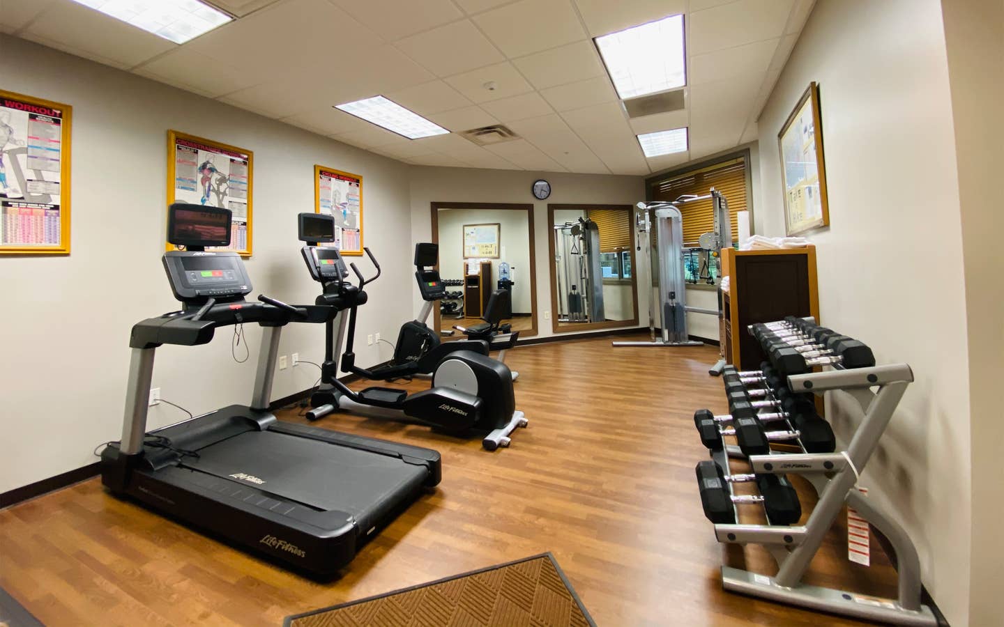 Fitness center with a treadmill, stationary bicycle, elliptical and free weights at Smoky Mountain Resort in Gatlinburg, Tennessee.
