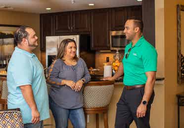 A couple standing with a salesman in a villa located at Orange Lake Resort in Orlando, FL