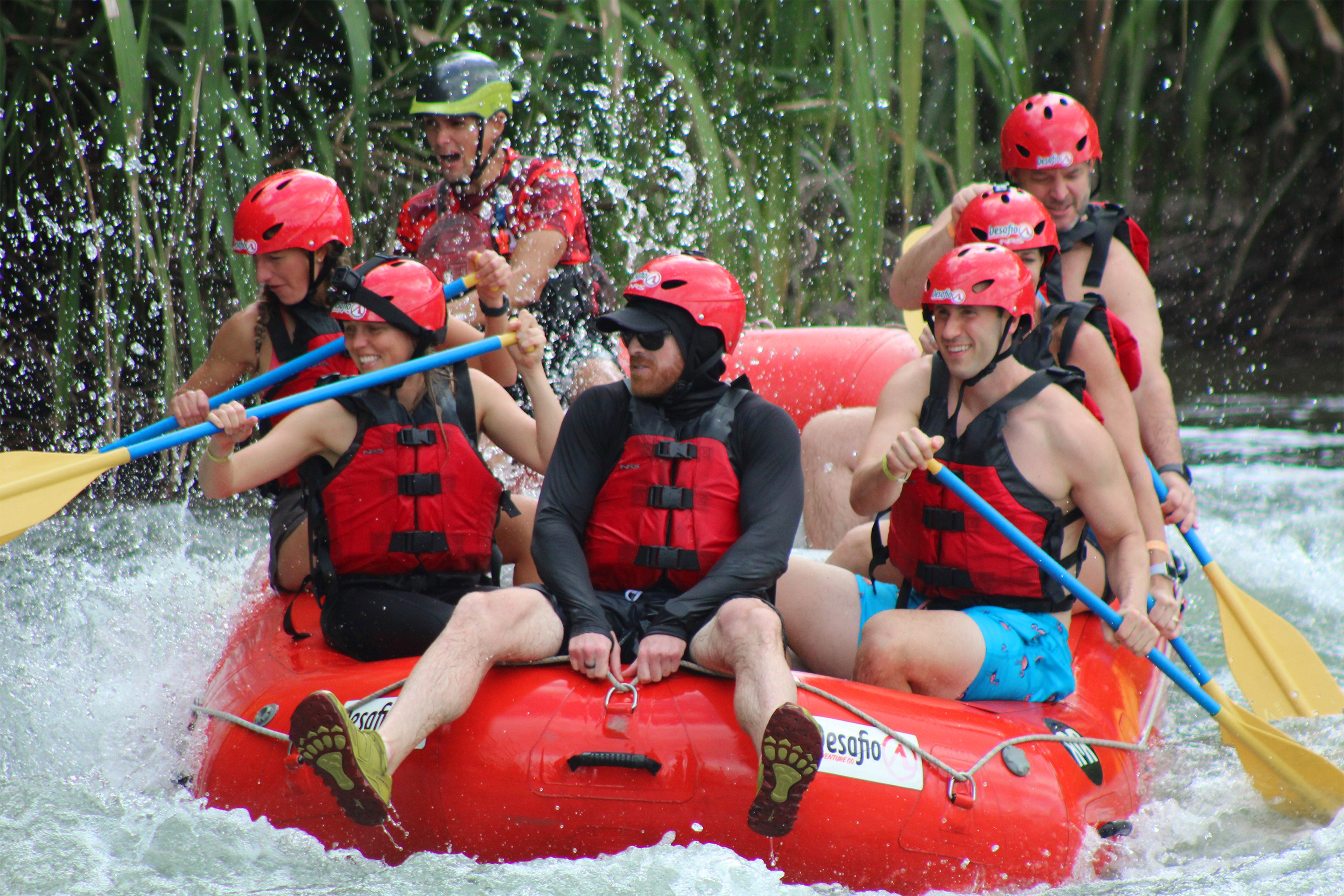 Featured contributor, Tiffany (front-left) and her husband (front-right) paddle a water raft in Costa Rica.