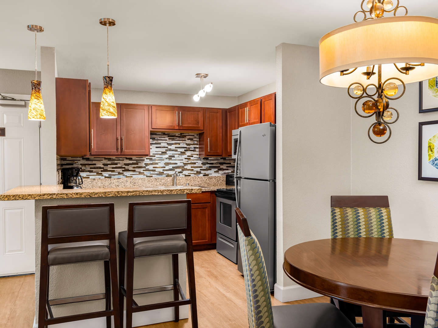 Warm kitchen and dining area with granite countertops.

