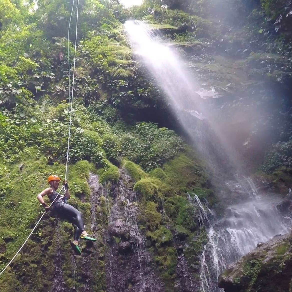 Featured contributor, Tiffany rappelling down a waterfall in Costa Rica.