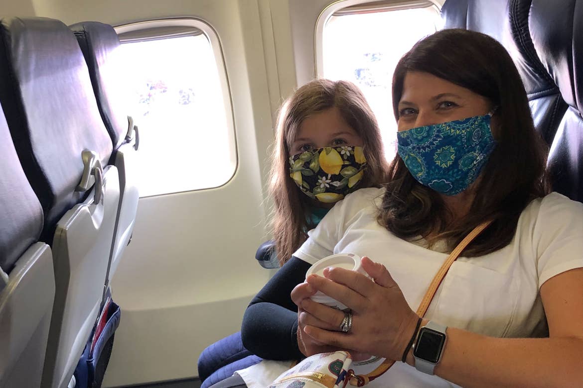 Chris (right) with daughter (left) wearing masks while on an Airplane for safety.