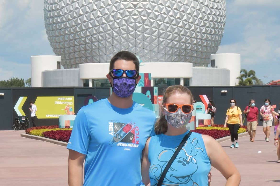 Featured author, Jessica Salina, and her Husband stand in front of Spaceship Earth at EPCOT at Walt Disney World resort.